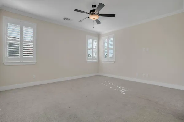 an empty room with a window and a ceiling fan