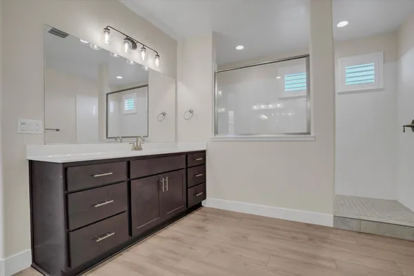 a bathroom with a double vanity sink and a mirror