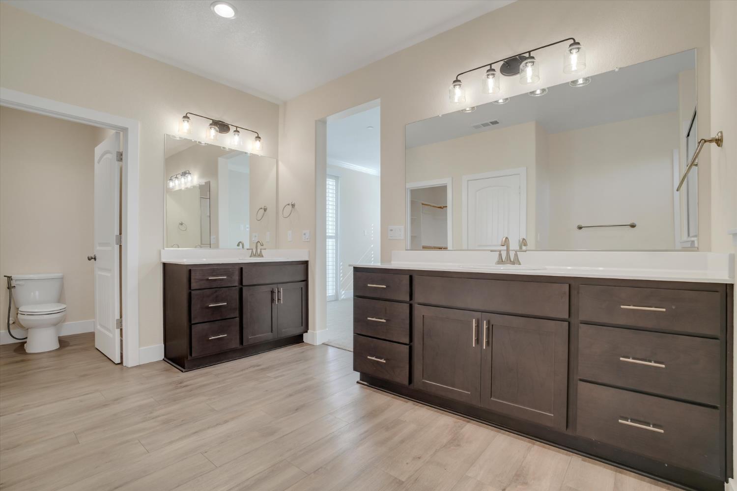 1898 Sanza Road Manteca, CA 95337 - Photo 19 of 41 a bathroom with a granite countertop double vanity sink mirror and a toilet