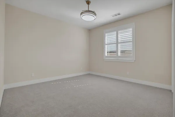 an empty room with a empty space and windows