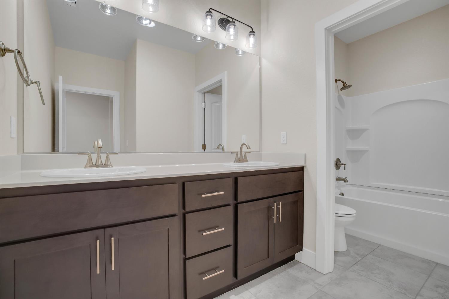 1898 Sanza Road Manteca, CA 95337 - Photo 27 of 41 a bathroom with a sink double vanity and a bathtub