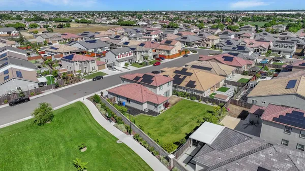 an aerial view of residential houses with outdoor space