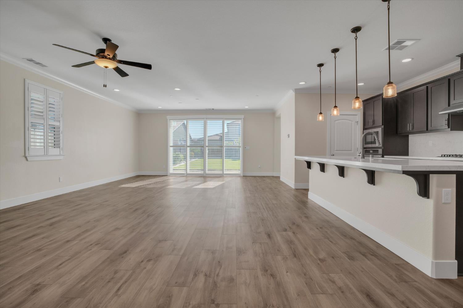 1898 Sanza Road Manteca, CA 95337 - Photo 8 of 41 a view of an empty room with wooden floor and a window