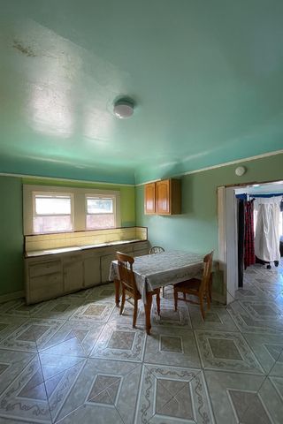 a room with furniture a air conditioner vent and a window