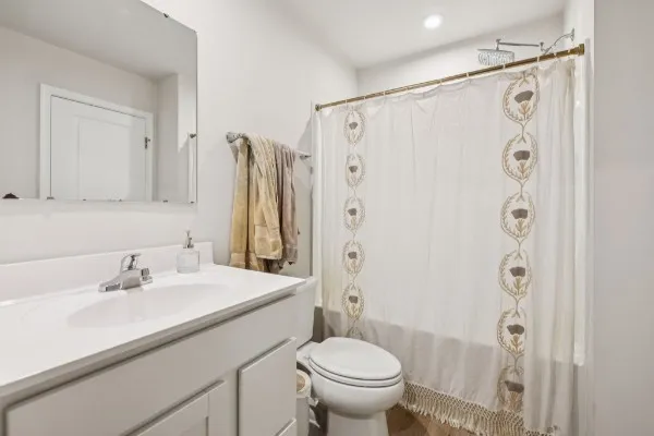 a bathroom with a sink shower and a toilet