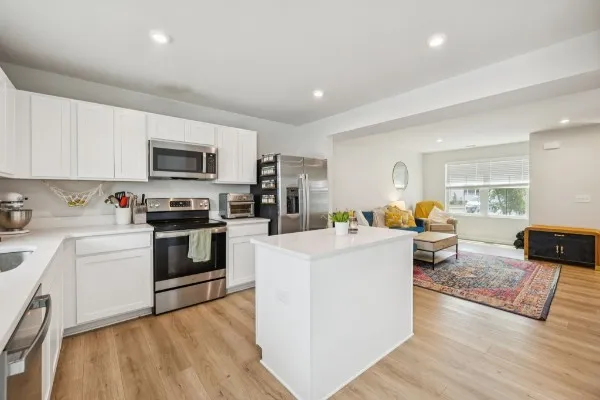 a kitchen with stove a sink and appliances