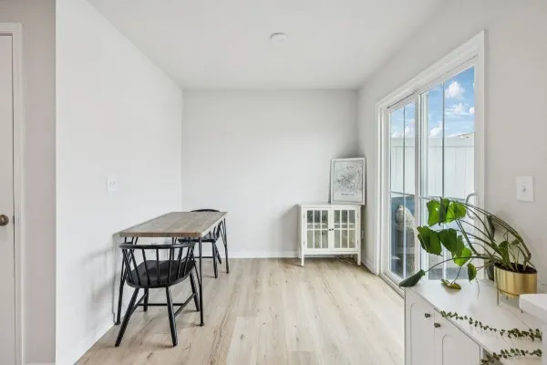 a dining room with furniture and wooden floor