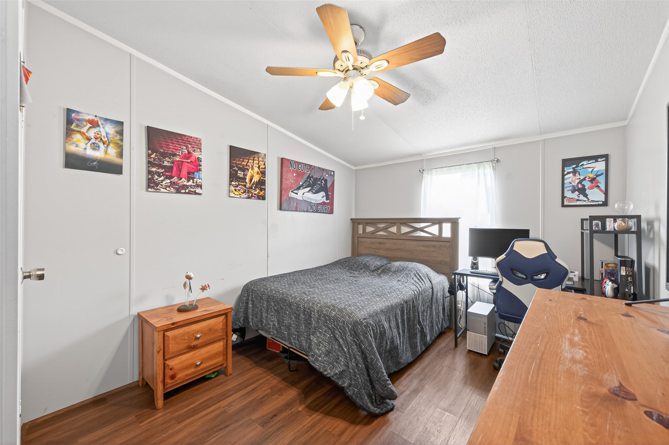16572 River Ranch Drive Conroe, TX 77302 - Photo 12 of 18 a bedroom with a bed and a chandelier