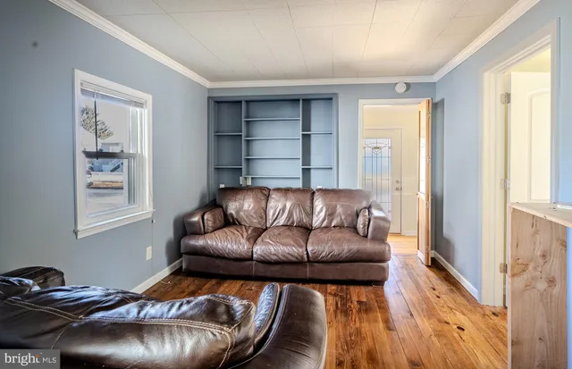 a living room with a couch and a window