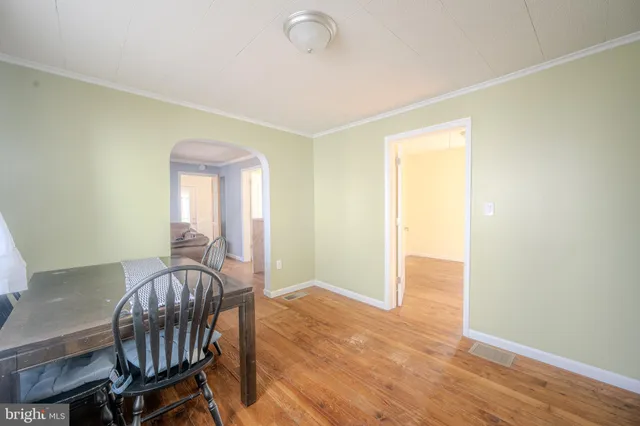 a view of a room with furniture and wooden floor