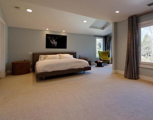115 Lockwood Road Riverside, CT 06878 - Photo 7 of 10 a spacious bedroom with a bed and large windows