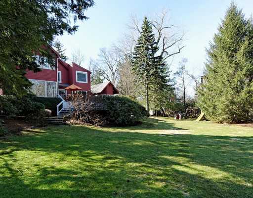 115 Lockwood Road Riverside, CT 06878 - Photo 8 of 10 a view of a big house with a big yard and large trees