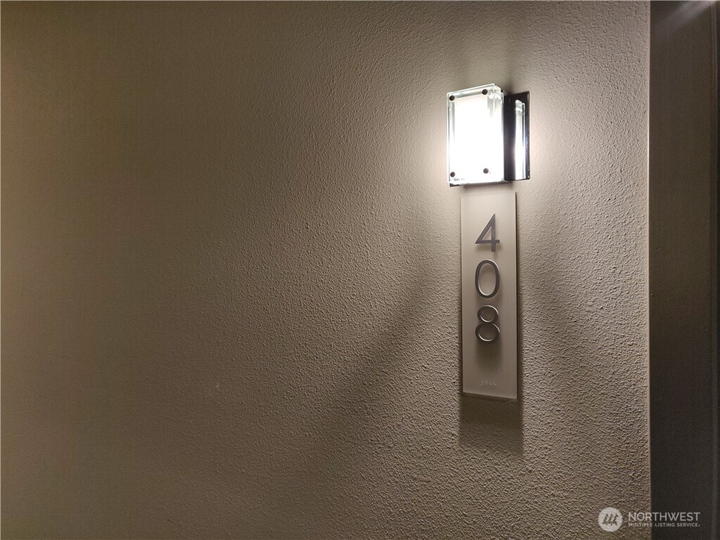 4547 8th Avenue Northeast, Unit 408 Seattle, WA 98105 - Photo 12 of 27 a view of a livingroom with a white door and a window