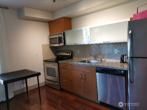 4547 8th Avenue Northeast, Unit 408 Seattle, WA 98105 - Photo 18 of 27 a kitchen with a sink cabinets and wooden floor