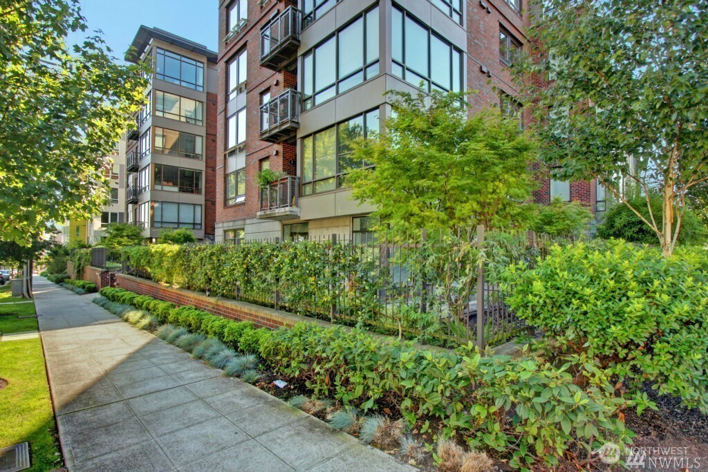 4547 8th Avenue Northeast, Unit 408 Seattle, WA 98105 - Photo 2 of 27 a view of a building with a yard