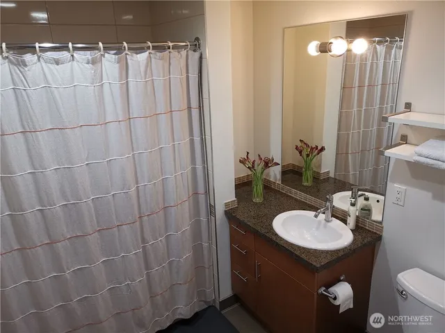 a bedroom with a bed and a potted plant