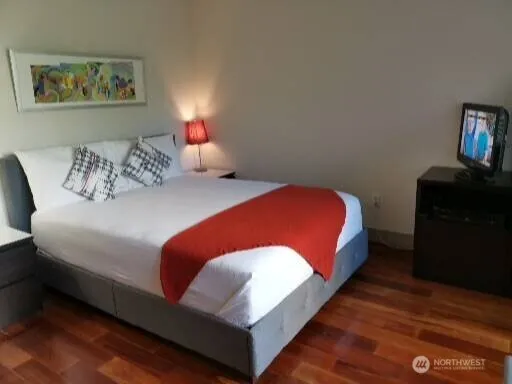 a bedroom with a bed and a dresser