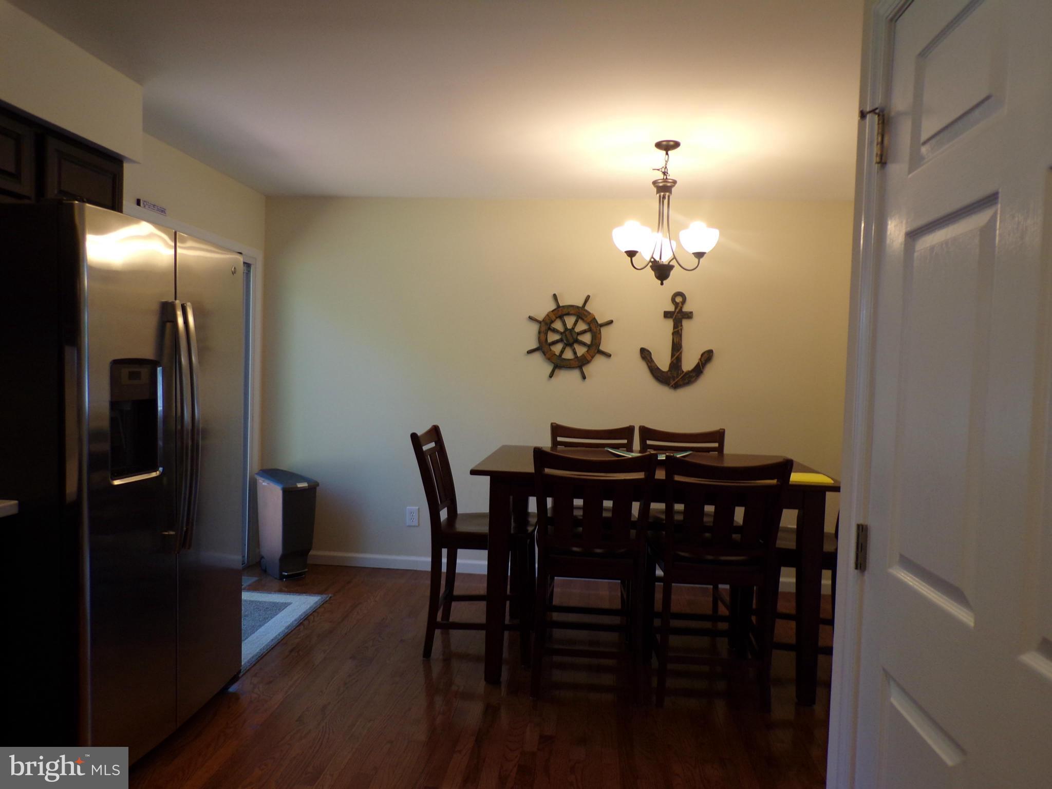 520 Brentwood Road Edgewater, MD 21037 - Photo 6 of 18 a view of a dining room with furniture and wooden floor