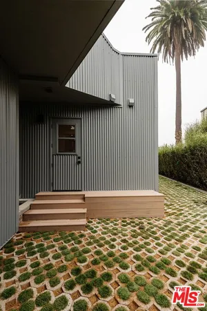 a side view of a house with a yard