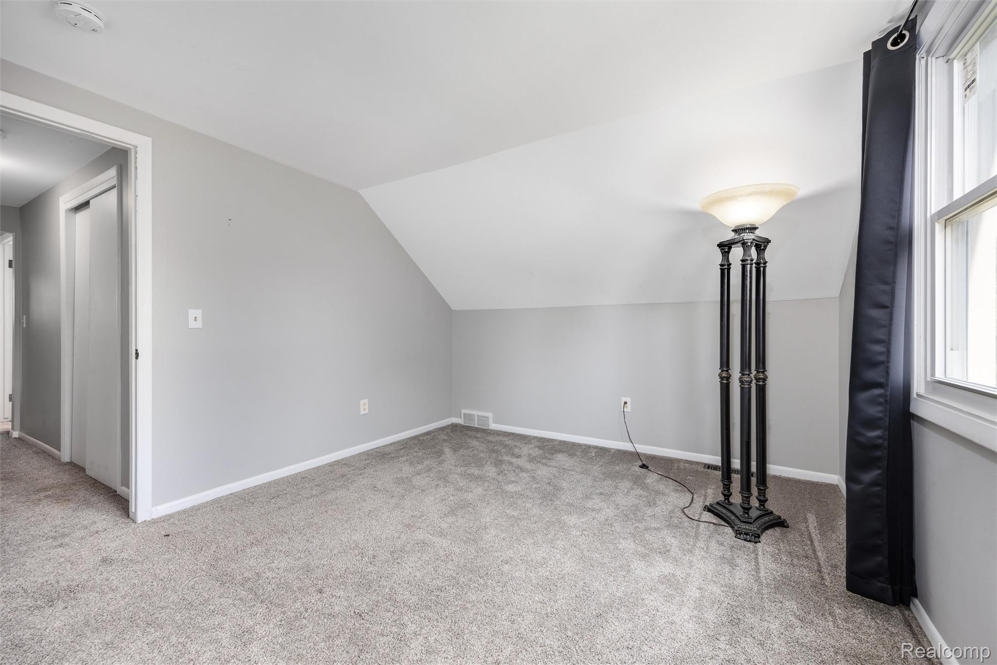 4942 Butler Drive Troy, MI 48085 - Photo 27 of 33 Carpeted room featuring a sloped ceiling and light gray wall paint
