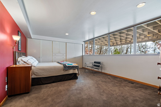 1856 Fort Canyon Road Alpine, UT 84004 - Photo 20 of 49 Room featuring a built-in wall of cabinetry, a floor-to-ceiling window wall with exterior grid detailing, recessed ceiling lighting, and a red accent wall