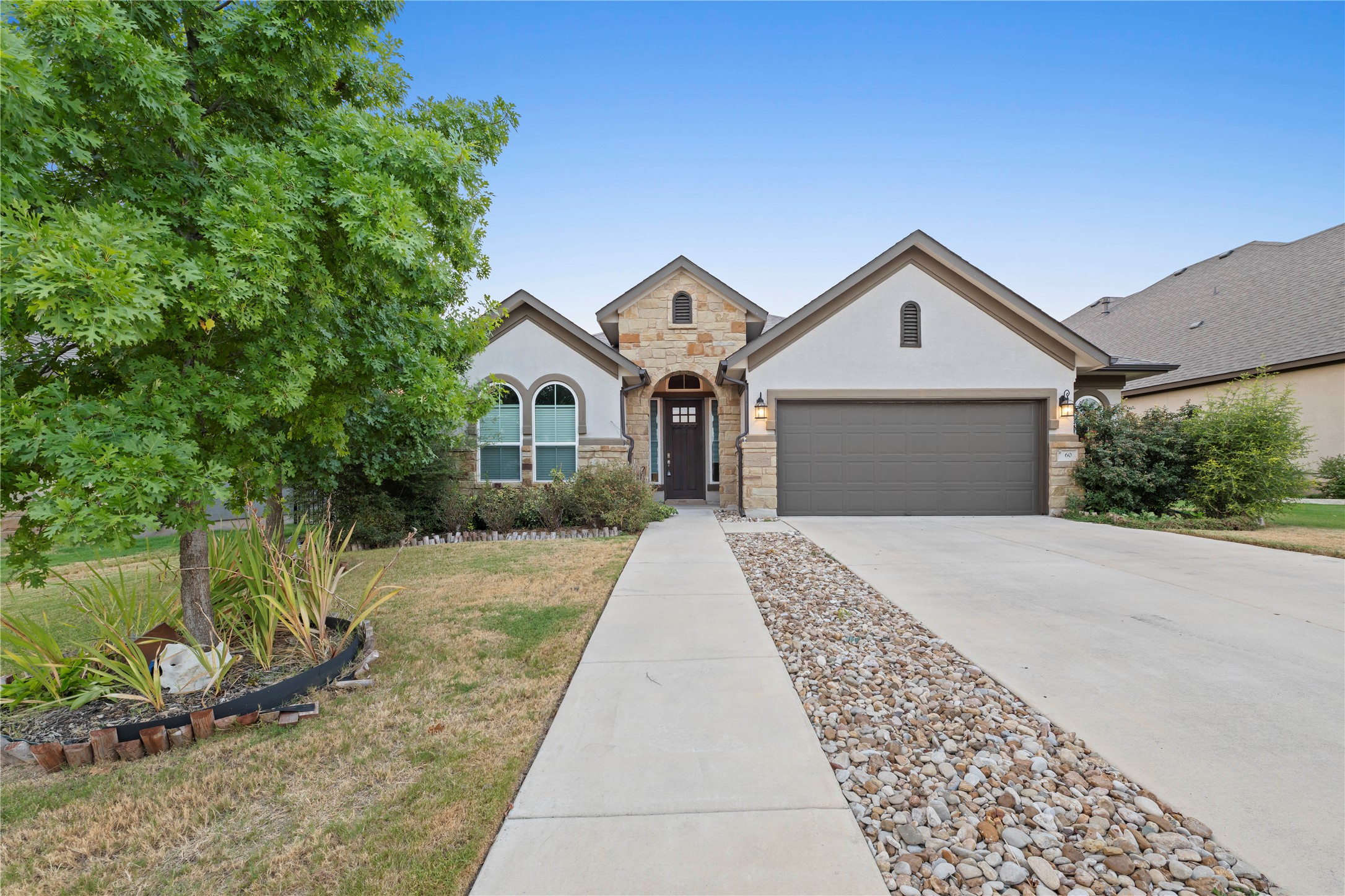 60 Rancho Trail Georgetown, TX 78628 - Photo 31 of 36 Gabled rooflines and a stone-accented facade create striking curb appeal for this single-story home.