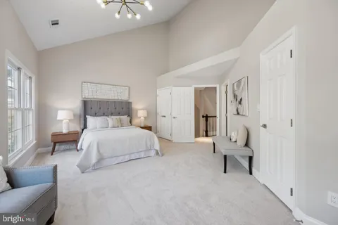 a bedroom with a bed and a chandelier