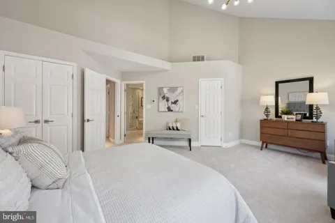 a bedroom with a bed and a mirror