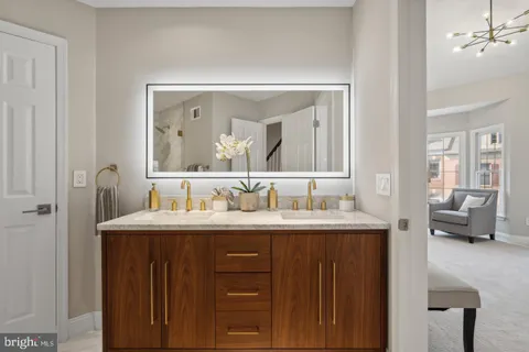a en suite bathroom with a granite countertop sink a mirror and a