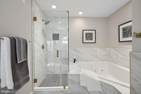 a bathroom with a bathtub and a shower