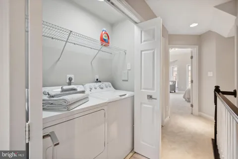 a utility room with cabinets washer and dryer