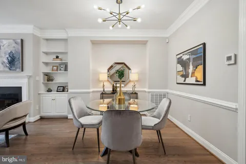 a view of a dining room with furniture wooden floor and a chandelier