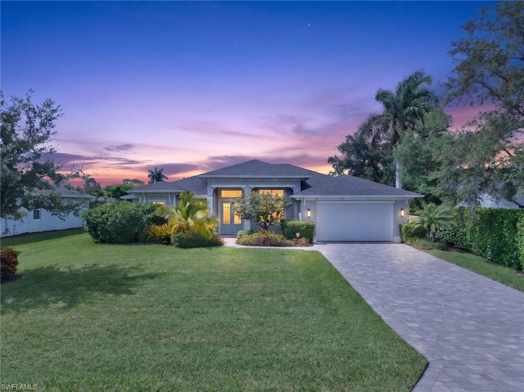 37 Johnnycake Drive Naples, FL 34110 - Photo 1 of 33 Single-story residence featuring a paver driveway, an attached two-car garage, and a covered entry