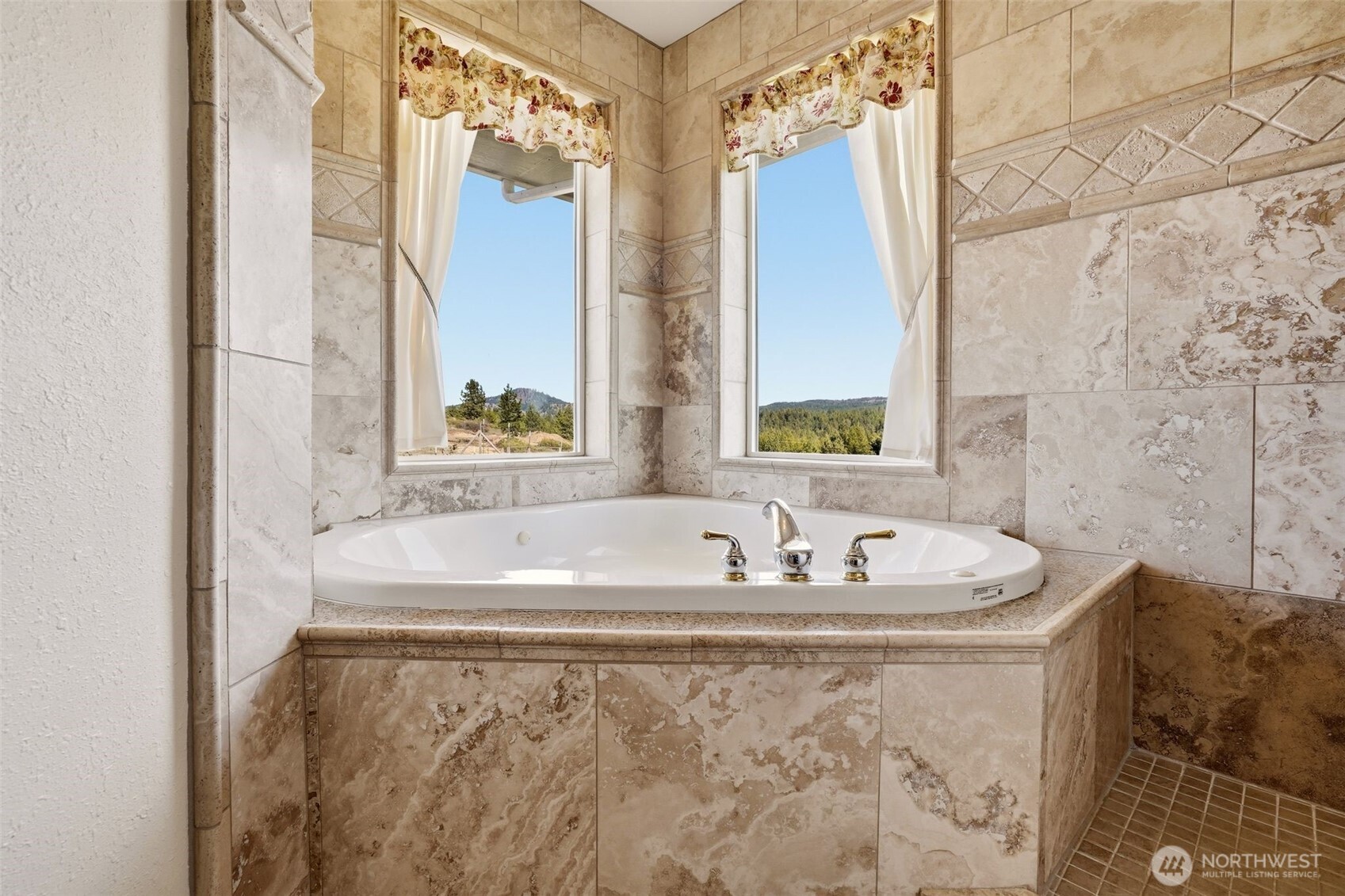 Undisclosed Address Elk, WA 99009 - Photo 19 of 40 a bath tub sitting in a bathroom next to a window