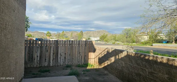a view of a pathway with a wrought fence