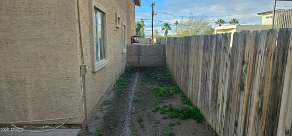 a view of a pathway of a wooden fence