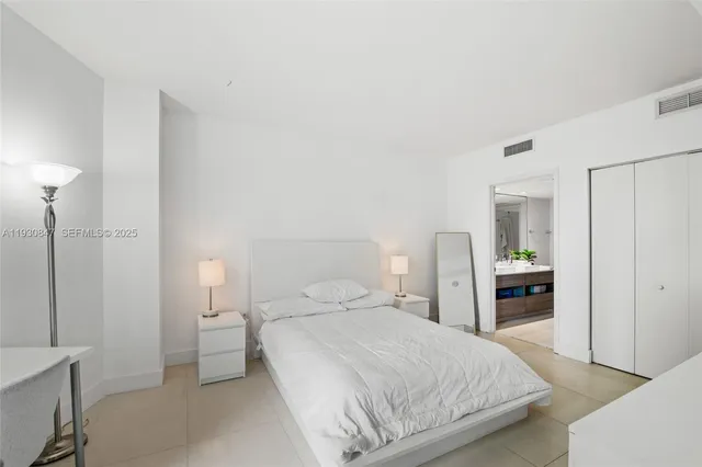 a bedroom with a bed and a lamp