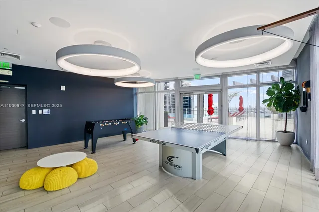 a living room with furniture and potted plants