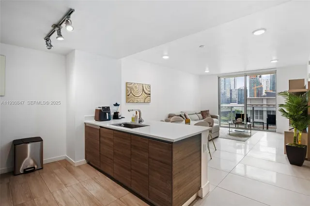 a view of a room with gym equipment and wooden floor