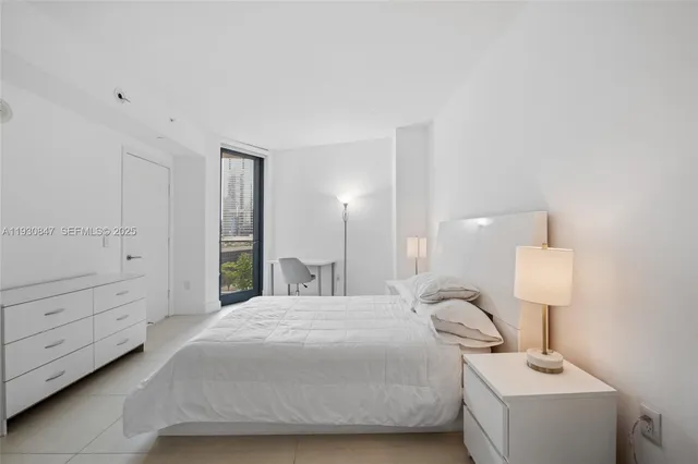 a bedroom with a bed and a night stand