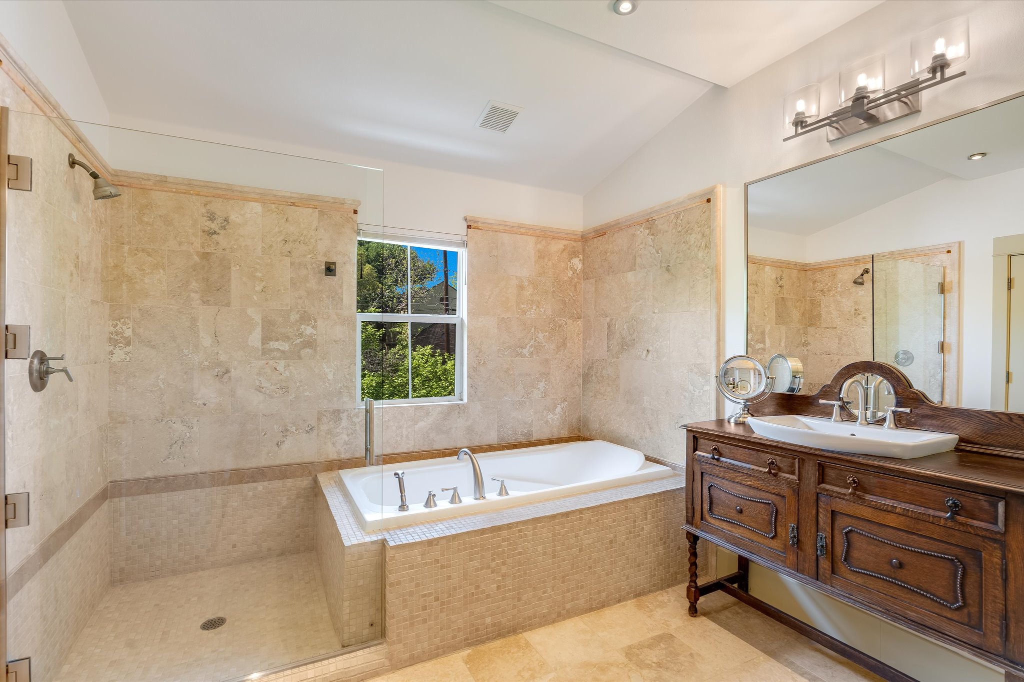 2405 Kinney Road, Unit 2405 Austin, TX 78704 - Photo 9 of 15 Separate shower, soaking tub, vaulted ceiling, antique vanity, and a walk in closet