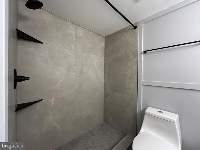 a bathroom with a toilet and shower