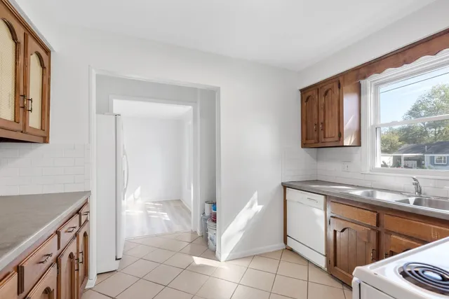 a kitchen that has a sink and a stove in it