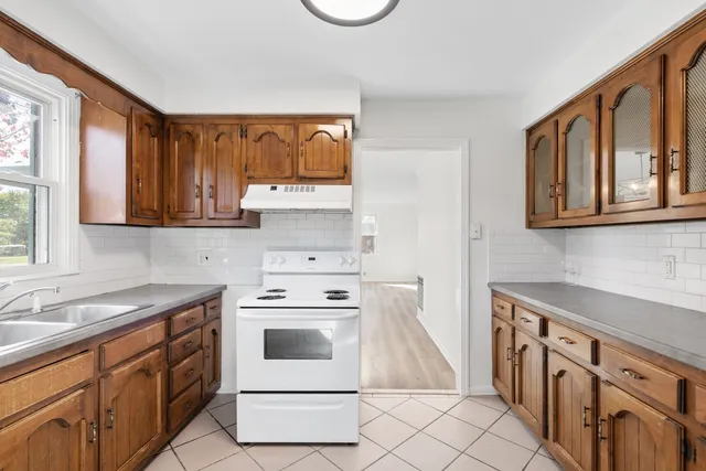 a kitchen with stainless steel appliances a stove a sink and a microwave