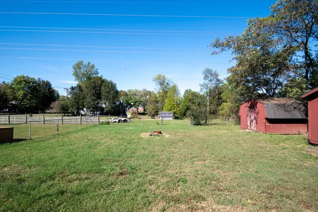 a backyard of apartments with large trees