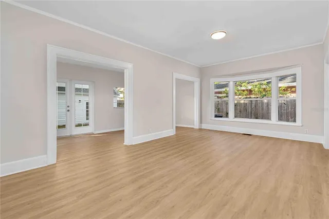 a view of a kitchen with a sink wooden floor and a window