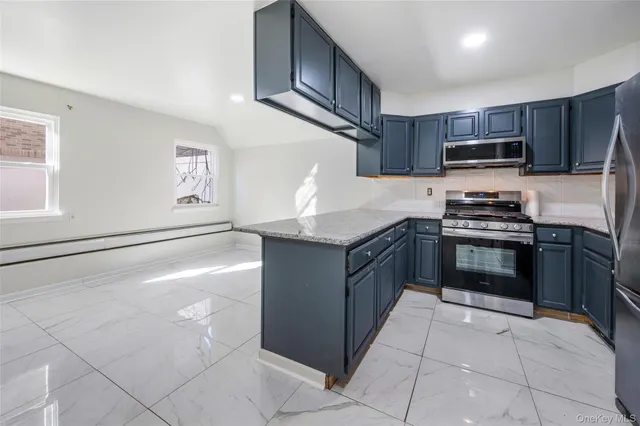 a kitchen with stainless steel appliances granite countertop a stove and a sink