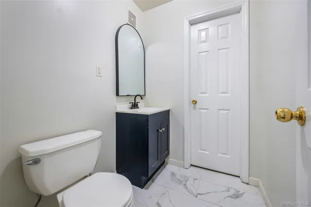 a white toilet sitting next to a bathroom sink