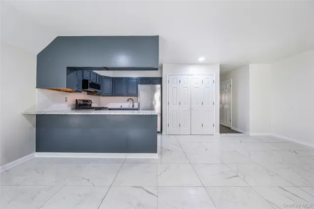 a kitchen with granite countertop a cabinets and a stove top oven
