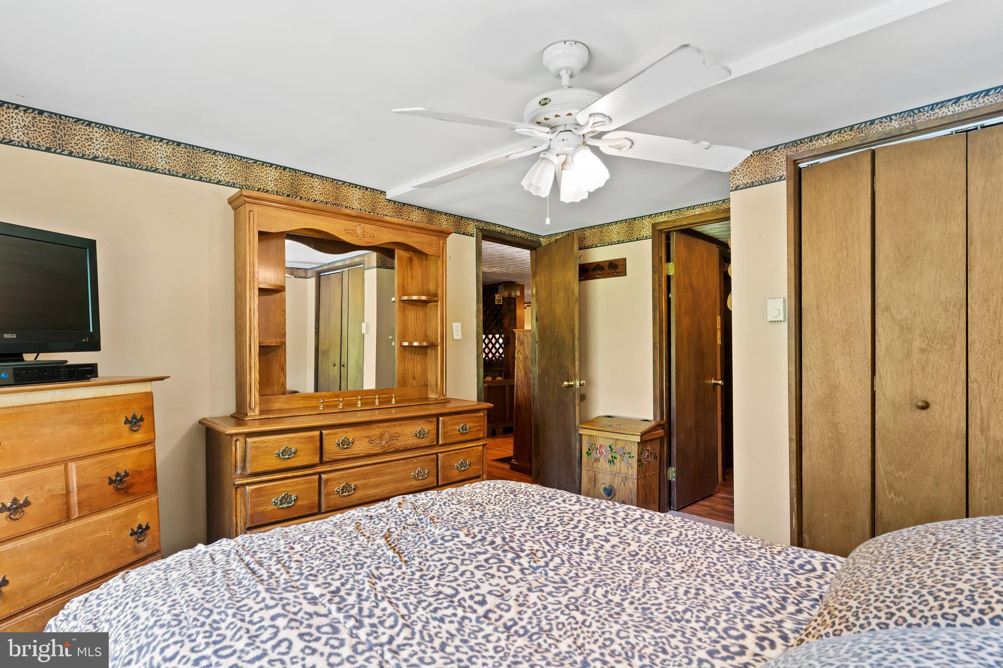 21429 Buck Trail Shade Gap, PA 17255 - Photo 13 of 42 a bedroom with a bed and a flat tv screen on dresser